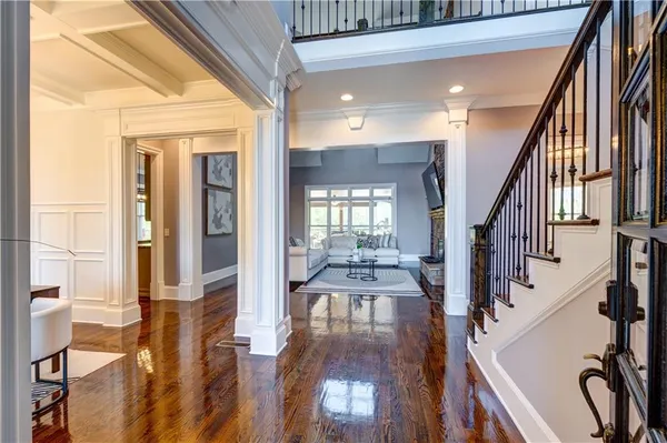 a view of an entryway with wooden floor and a livingroom
