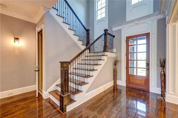 a view of entryway with wooden floor and stairs