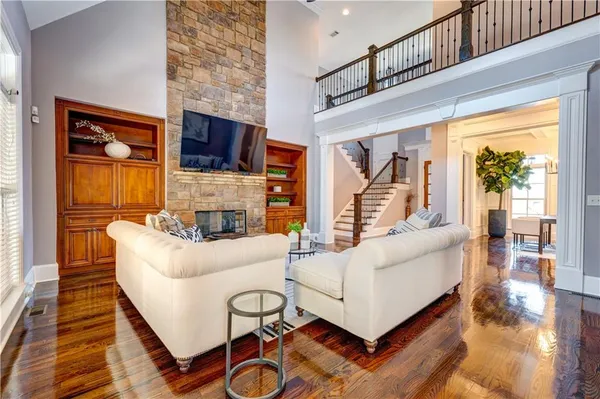 a living room with furniture a flat screen tv and a fireplace
