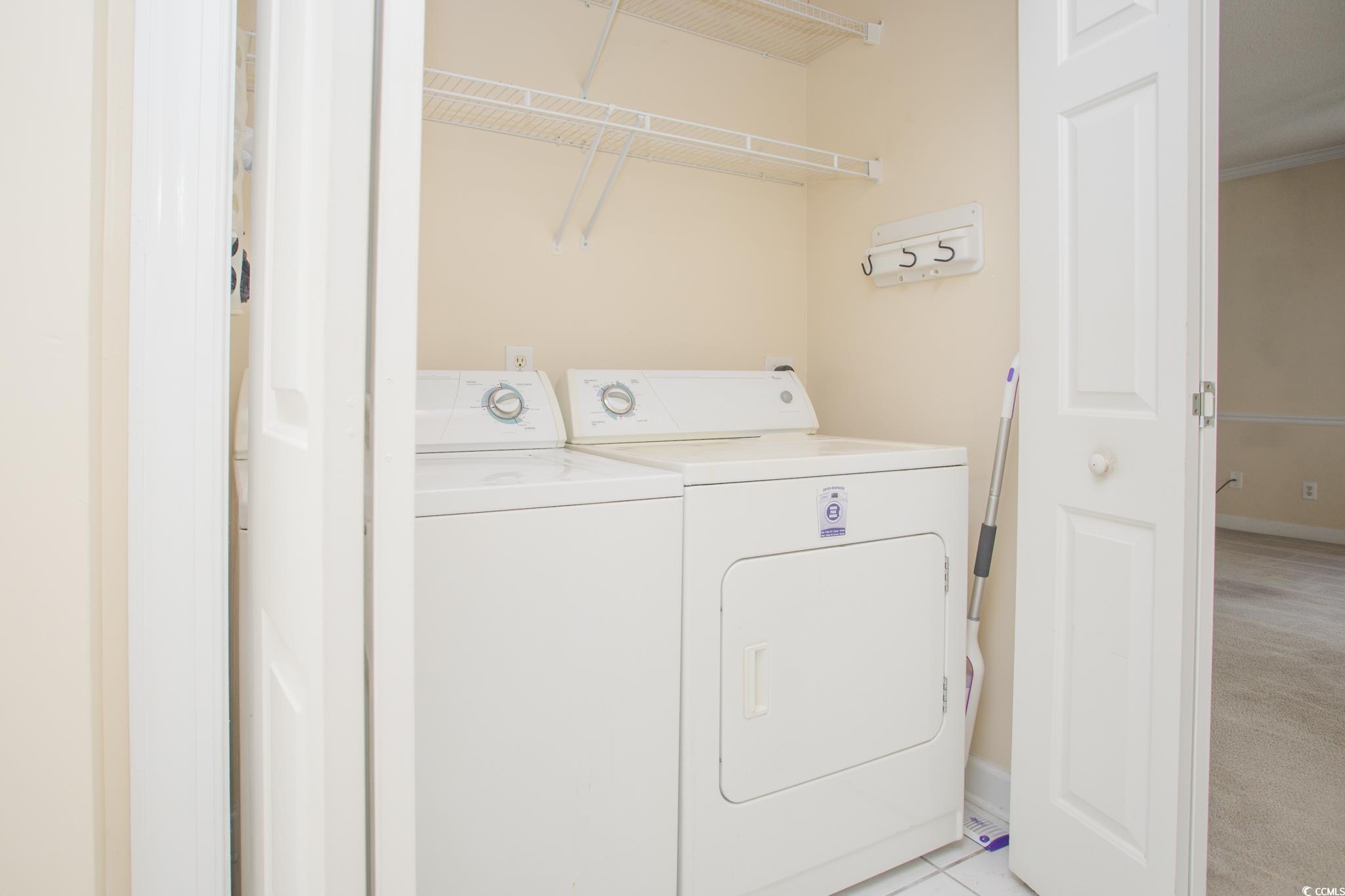 3979 Forsythia Court, Unit 204 Myrtle Beach, SC 29588 - Photo 16 of 29 Laundry room with washer and dryer and light tile patterned floors