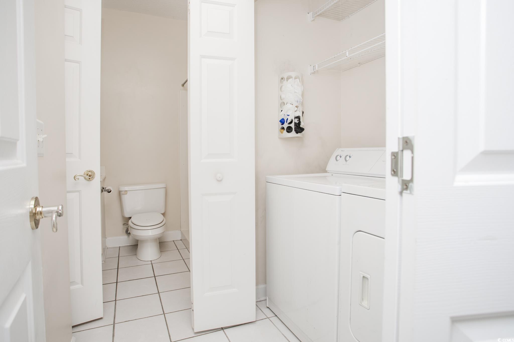 3979 Forsythia Court, Unit 204 Myrtle Beach, SC 29588 - Photo 6 of 29 Washroom with light tile patterned floors and washer and dryer