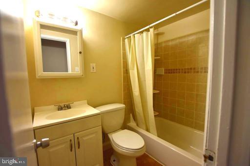 4313 Knox Road, Unit 501 College Park, MD 20740 - Photo 15 of 17 a bathroom with a sink mirror toilet and shower