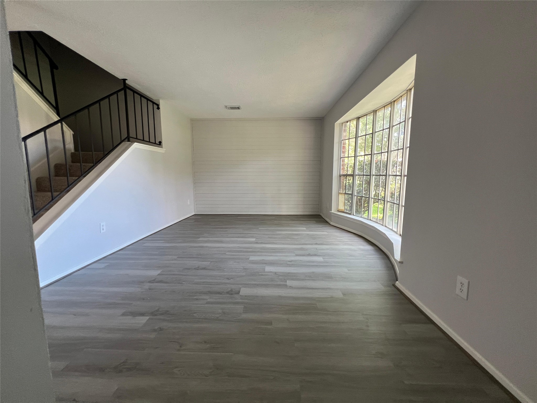7012 Jetty Lane Houston, TX 77072 - Photo 3 of 24 a view of an empty room with wooden floor and a window