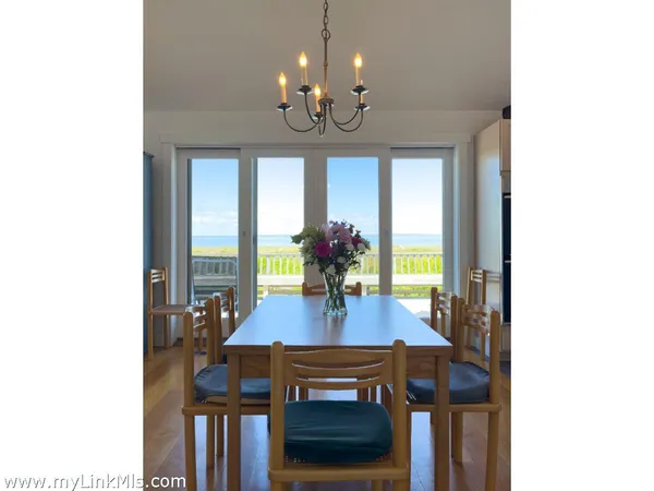 a view of a kitchen and dining room with wooden floor