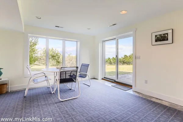 a living room with furniture and a floor to ceiling window