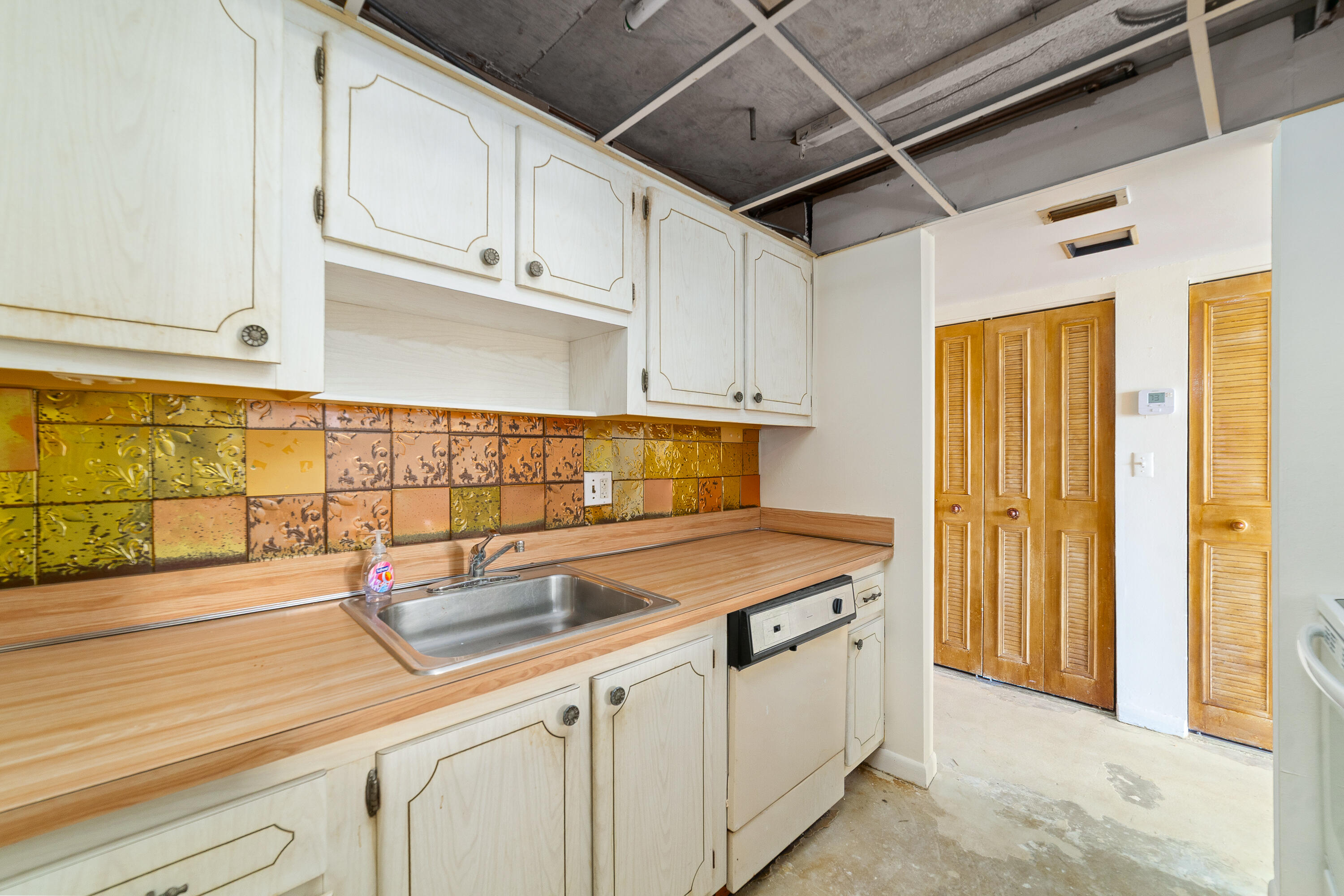 14221 Southwest 88th Street, Unit 303C Miami, FL 33186 - Photo 13 of 29 a kitchen with stainless steel appliances granite countertop a sink and cabinets