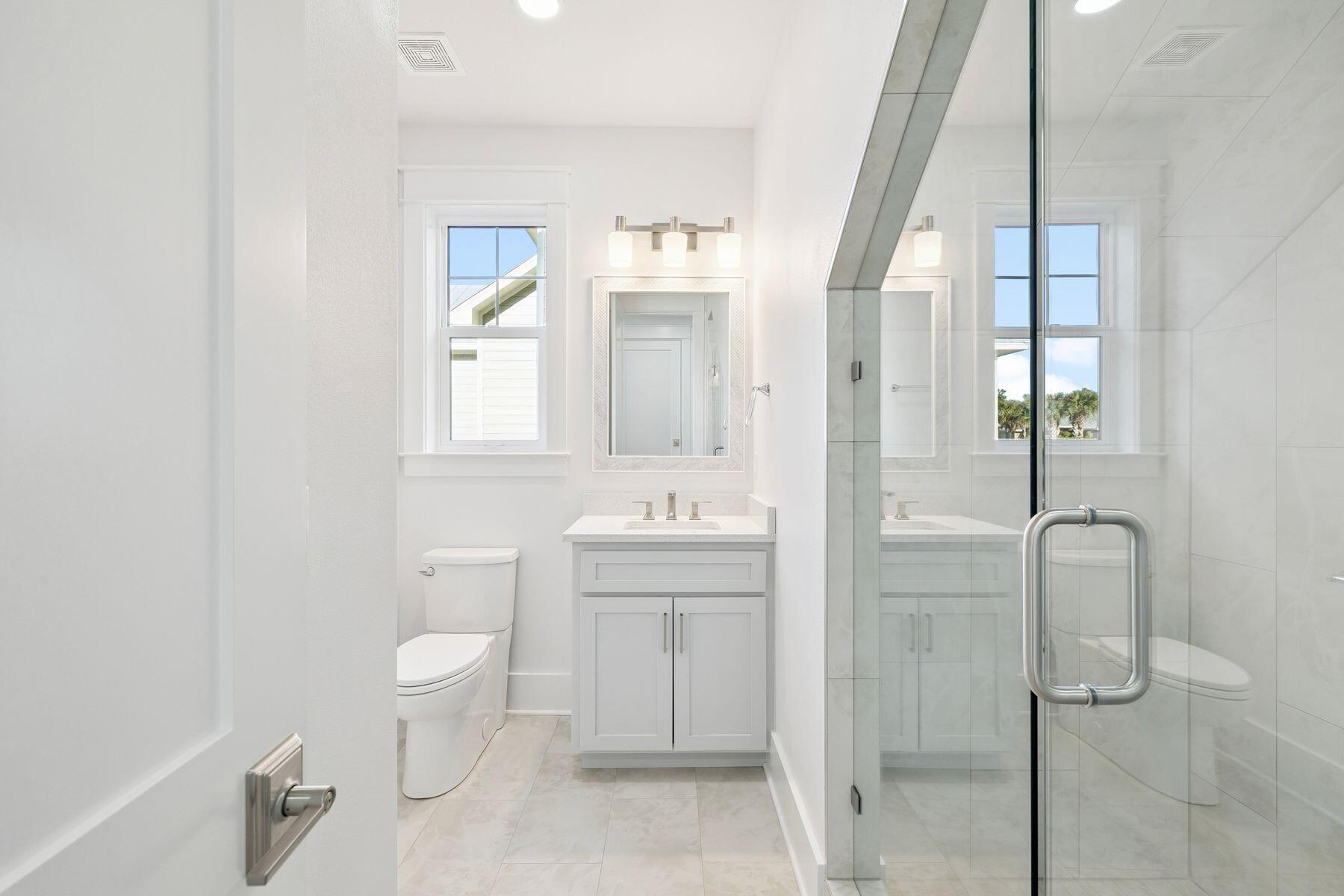 1885 West Hewett Road Santa Rosa Beach, FL 32459 - Photo 8 of 35 a bathroom with a toilet sink and mirror