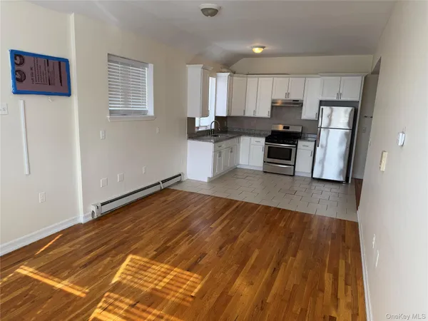 a kitchen with a refrigerator and a stove top oven