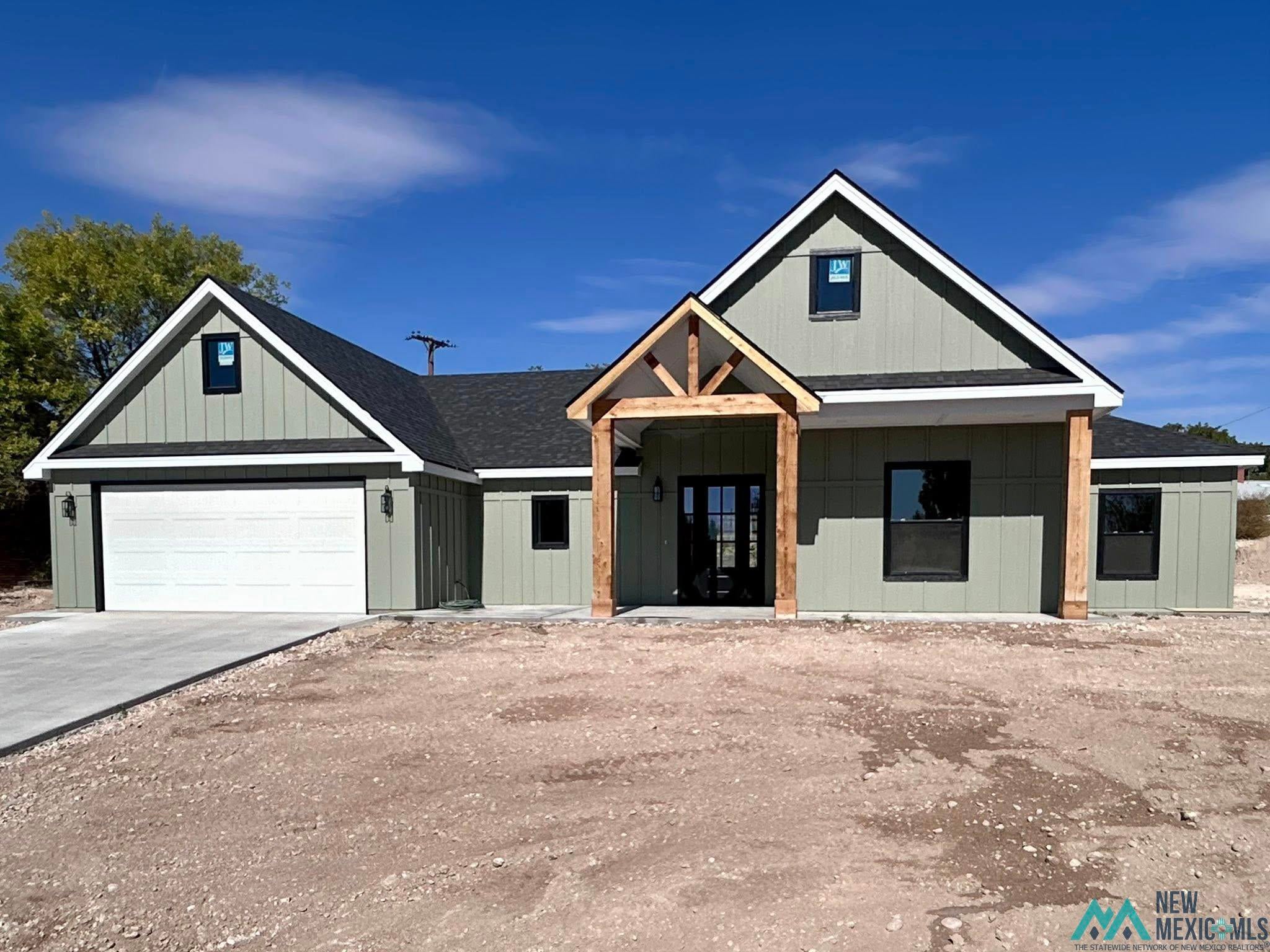 2607 Riverside Drive Roswell, NM 88201 - Photo 1 of 1 Modern farmhouse style home with a shingled roof, a porch, concrete driveway, and a garage