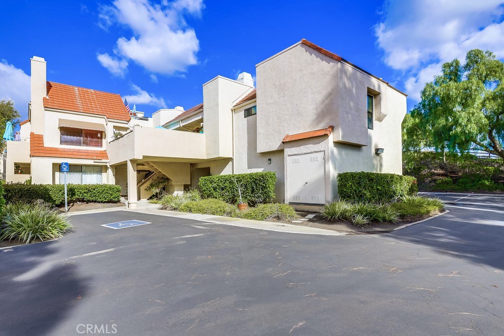 87 Grenada Street, Unit 174 Laguna Niguel, CA 92677 - Photo 16 of 17 a front view of a house with a yard and outdoor seating
