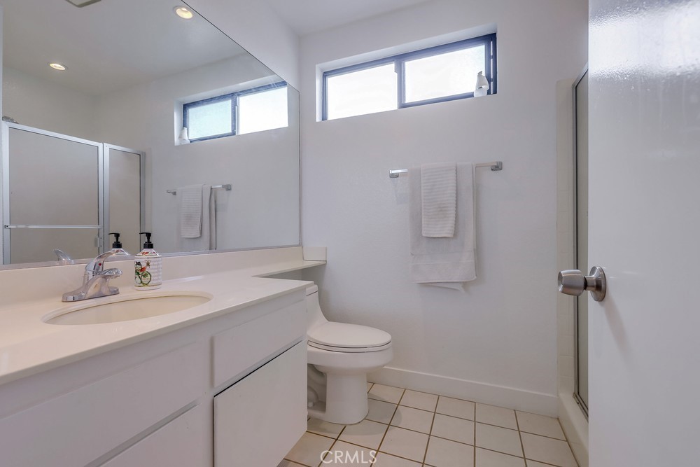 87 Grenada Street, Unit 174 Laguna Niguel, CA 92677 - Photo 9 of 17 a bathroom with a sink a toilet and mirror