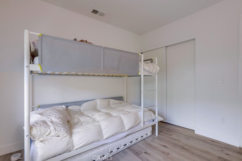 87 Grenada Street, Unit 174 Laguna Niguel, CA 92677 - Photo 10 of 17 a bedroom with a bed and a night stand