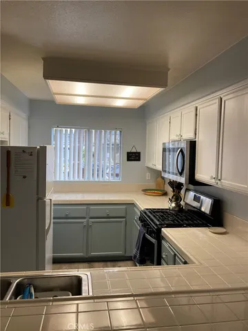 a kitchen with refrigerator and window