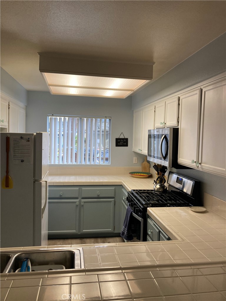 501 North Pacific Street, Unit 23 Oceanside, CA 92054 - Photo 5 of 24 a kitchen with refrigerator and window