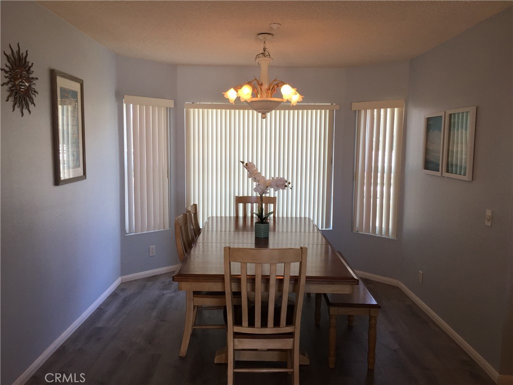 501 North Pacific Street, Unit 23 Oceanside, CA 92054 - Photo 7 of 24 a view of a dining room with furniture window and wooden floor