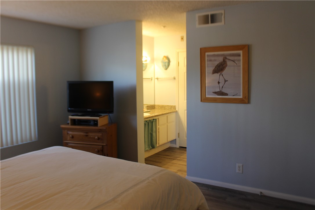 501 North Pacific Street, Unit 23 Oceanside, CA 92054 - Photo 10 of 24 a bedroom with a bed and a flat screen tv