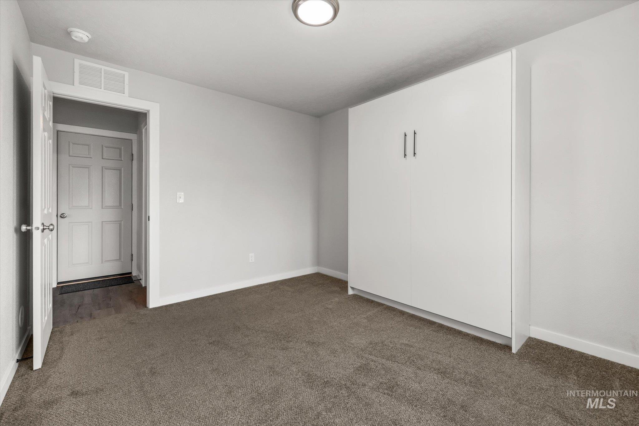 2024 Placerville Street Middleton, ID 83644 - Photo 13 of 38 Unfurnished room with baseboards and dark colored carpet