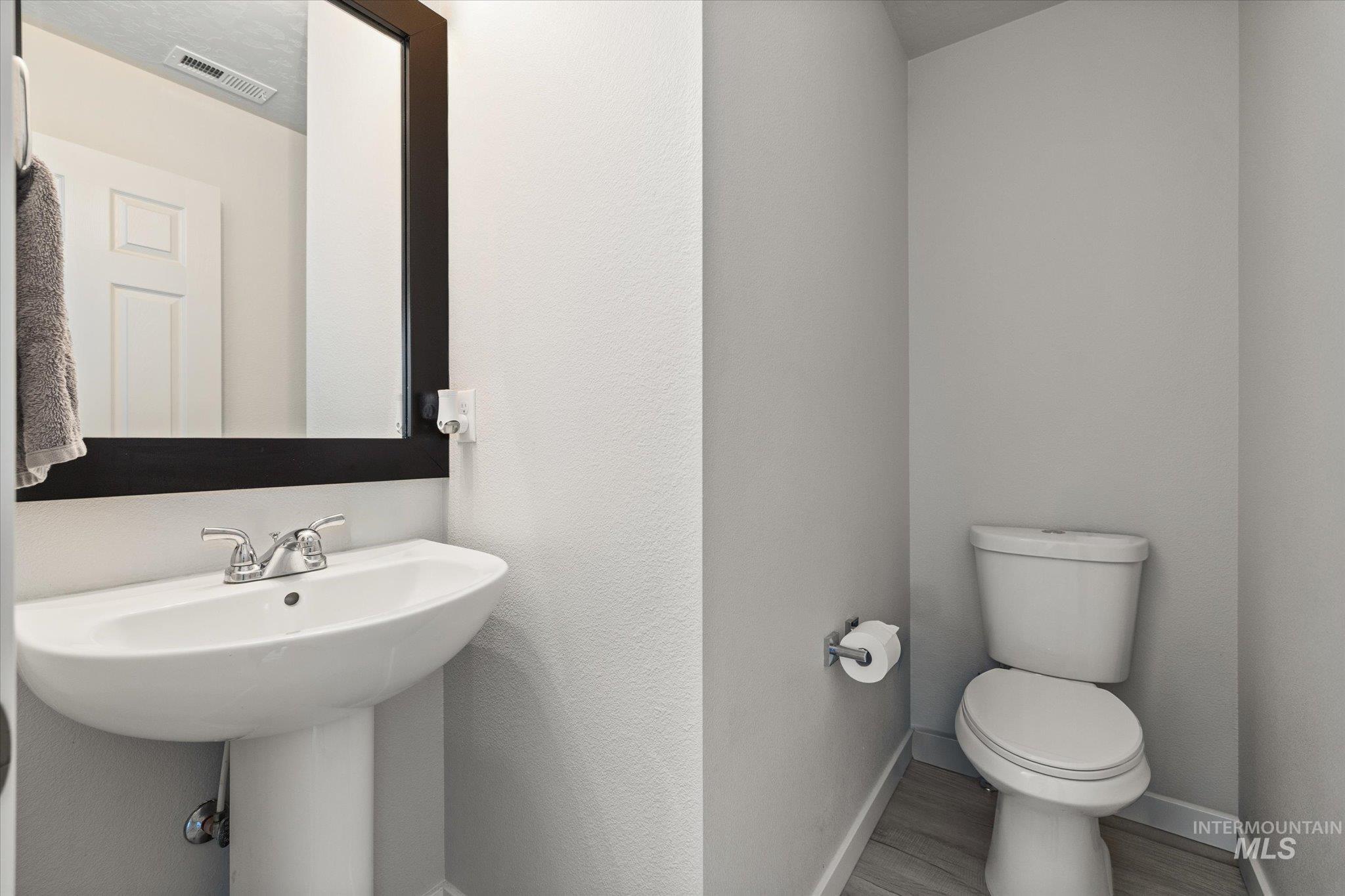 2024 Placerville Street Middleton, ID 83644 - Photo 14 of 38 Half bathroom featuring toilet and wood finished floors