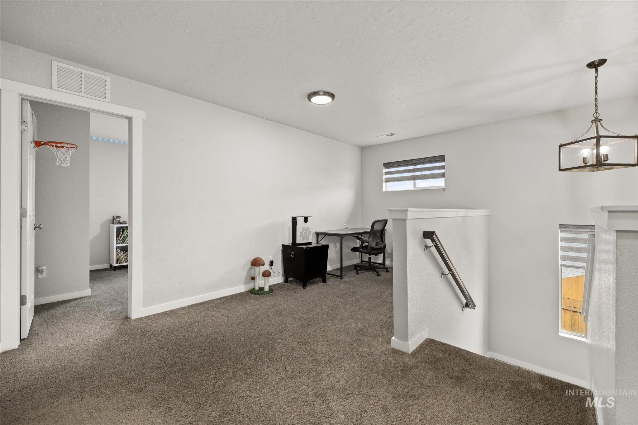 2024 Placerville Street Middleton, ID 83644 - Photo 15 of 38 Office space featuring dark carpet and hanging lights