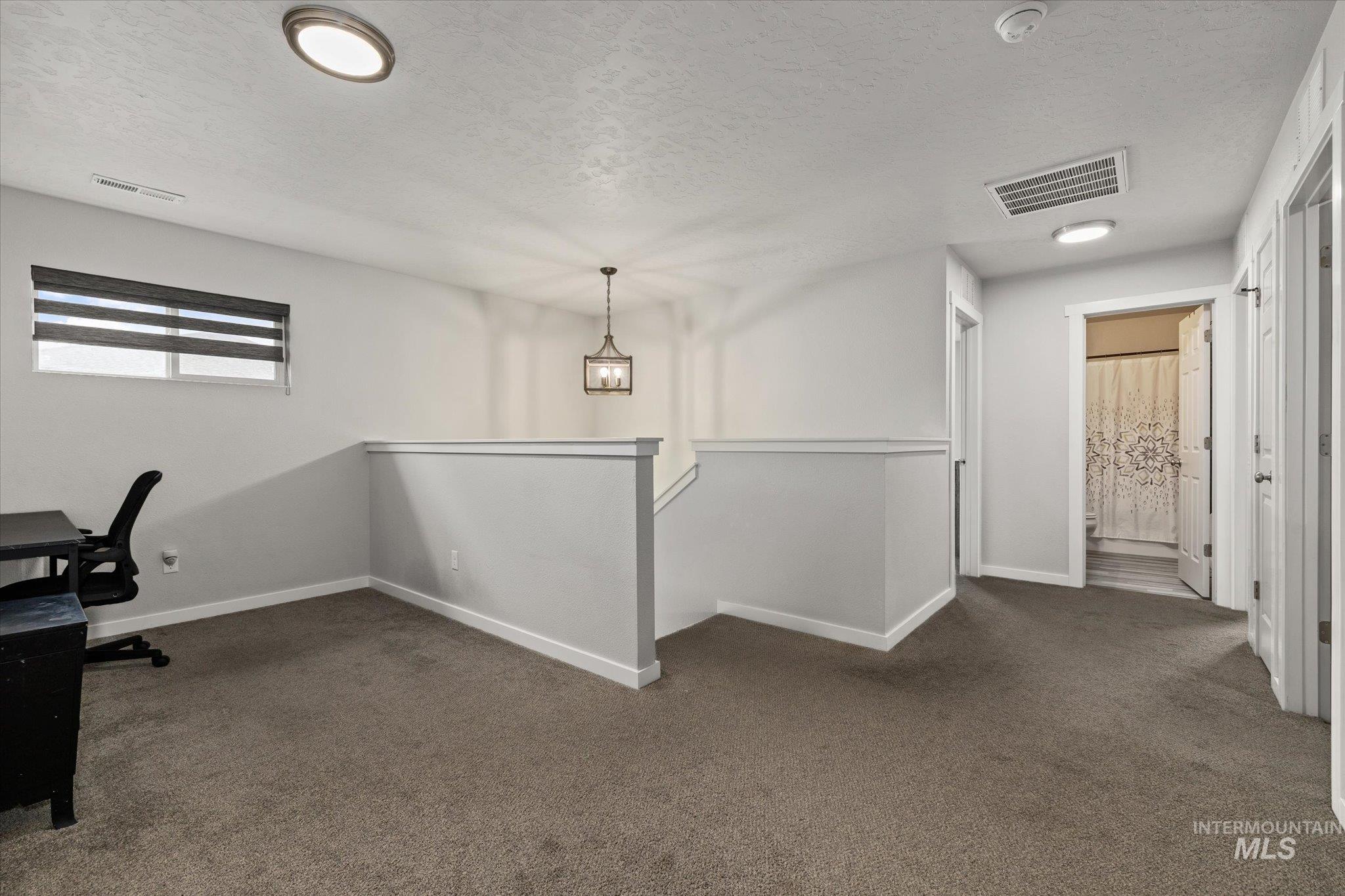2024 Placerville Street Middleton, ID 83644 - Photo 16 of 38 Unfurnished office featuring dark carpet and a textured ceiling