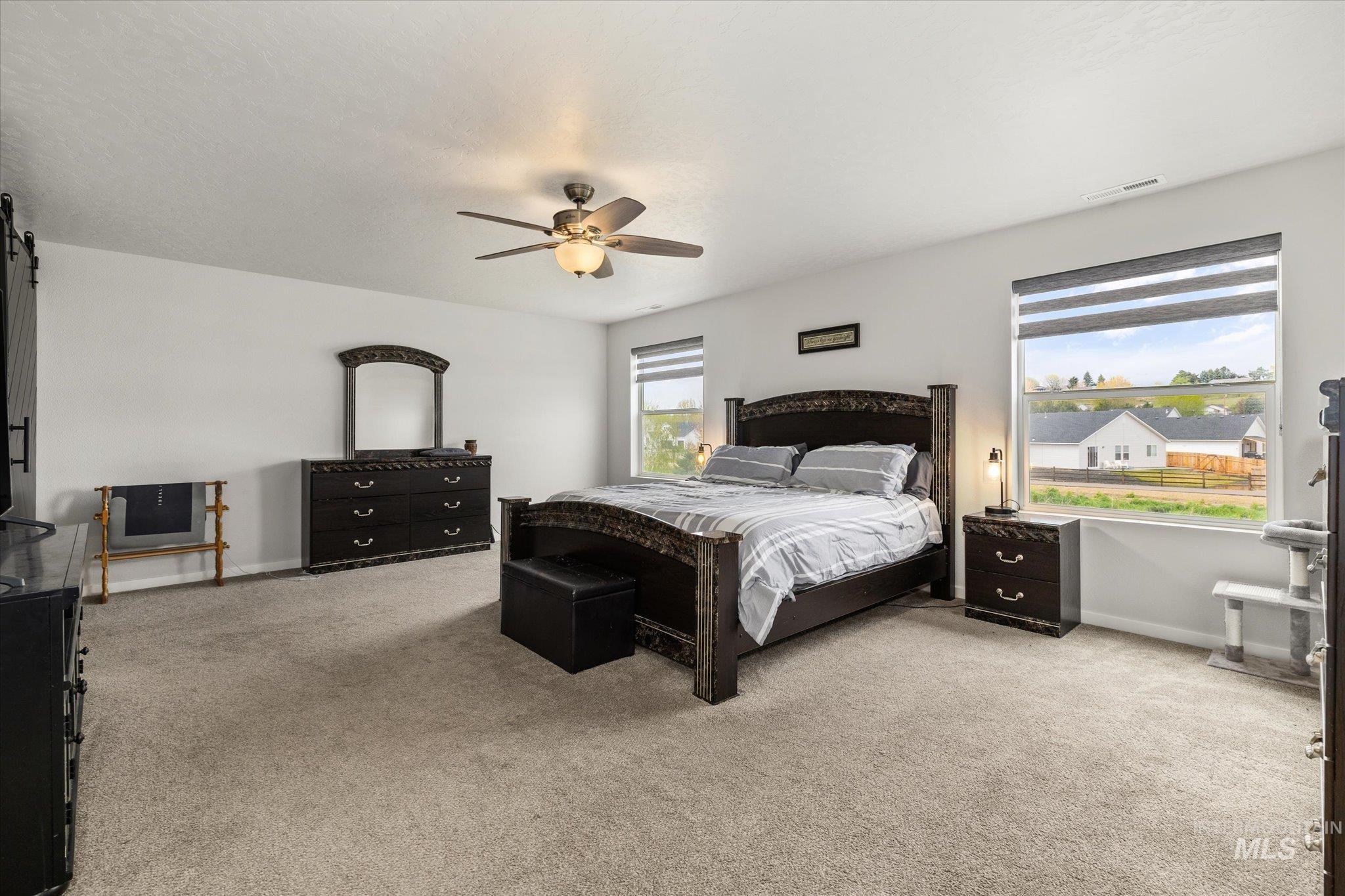 2024 Placerville Street Middleton, ID 83644 - Photo 17 of 38 Bedroom featuring light colored carpet and a ceiling fan