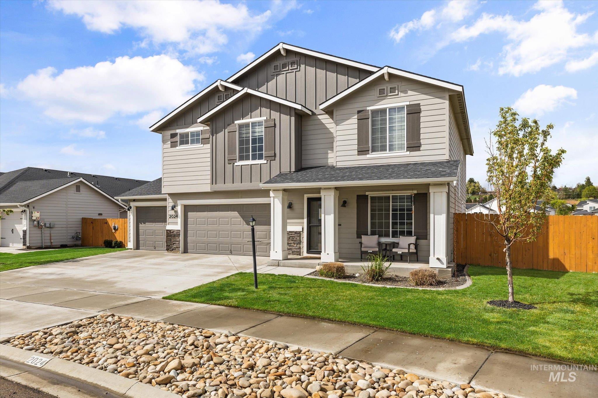 2024 Placerville Street Middleton, ID 83644 - Photo 2 of 38 View of front of house featuring a porch, an attached garage, driveway, and board and batten siding