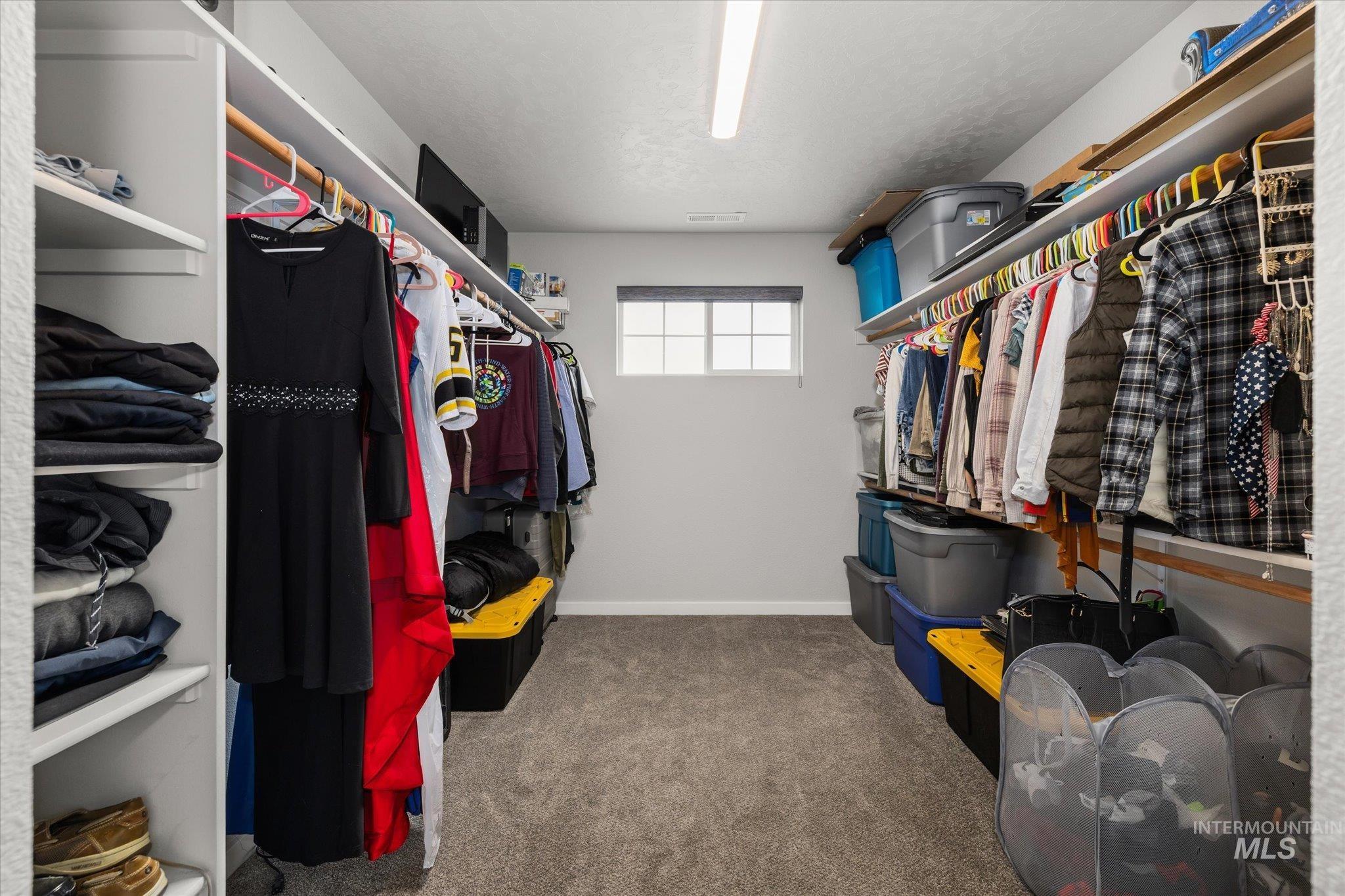 2024 Placerville Street Middleton, ID 83644 - Photo 23 of 38 Walk in closet with dark colored carpet