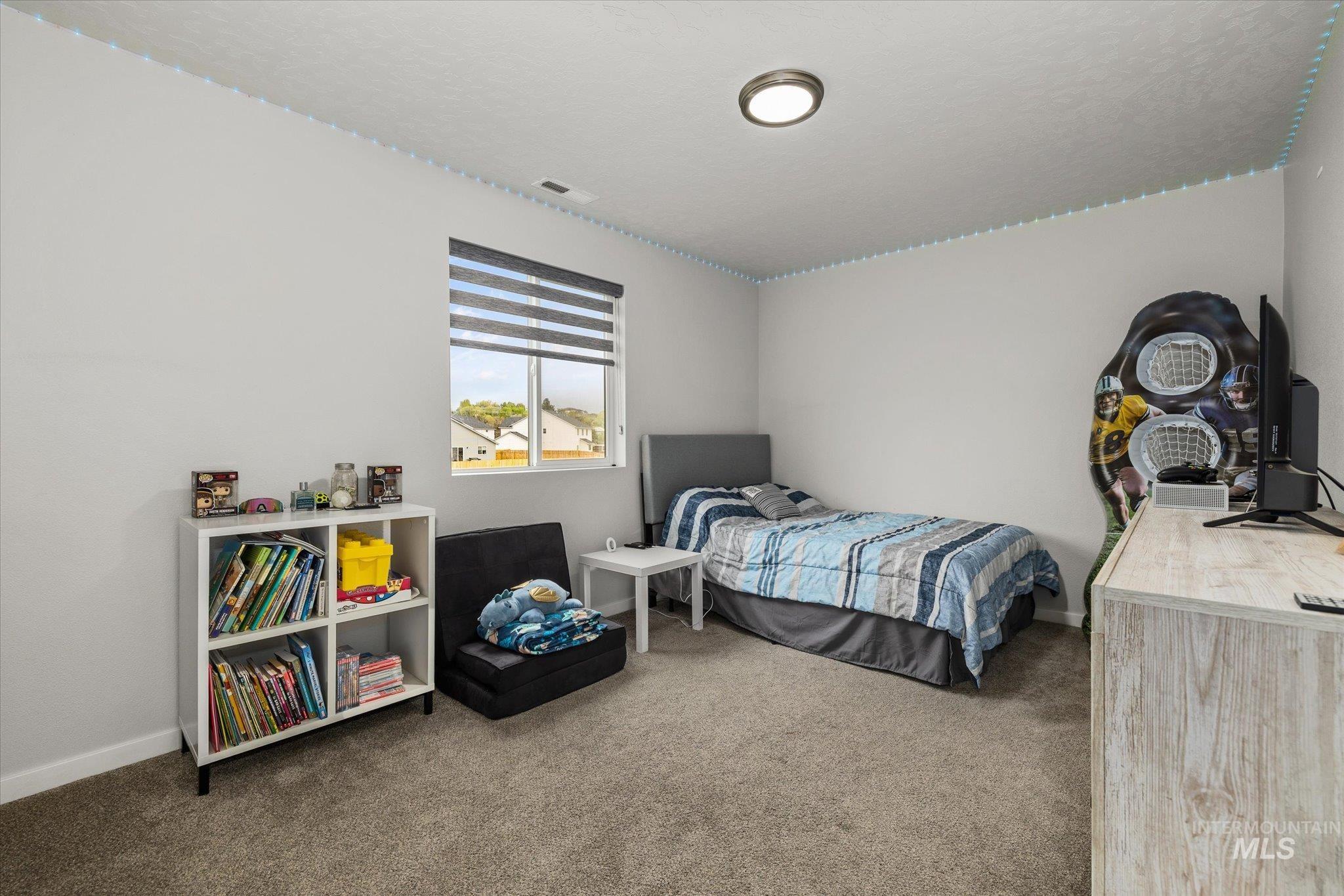 2024 Placerville Street Middleton, ID 83644 - Photo 24 of 38 Bedroom featuring light carpet and baseboards