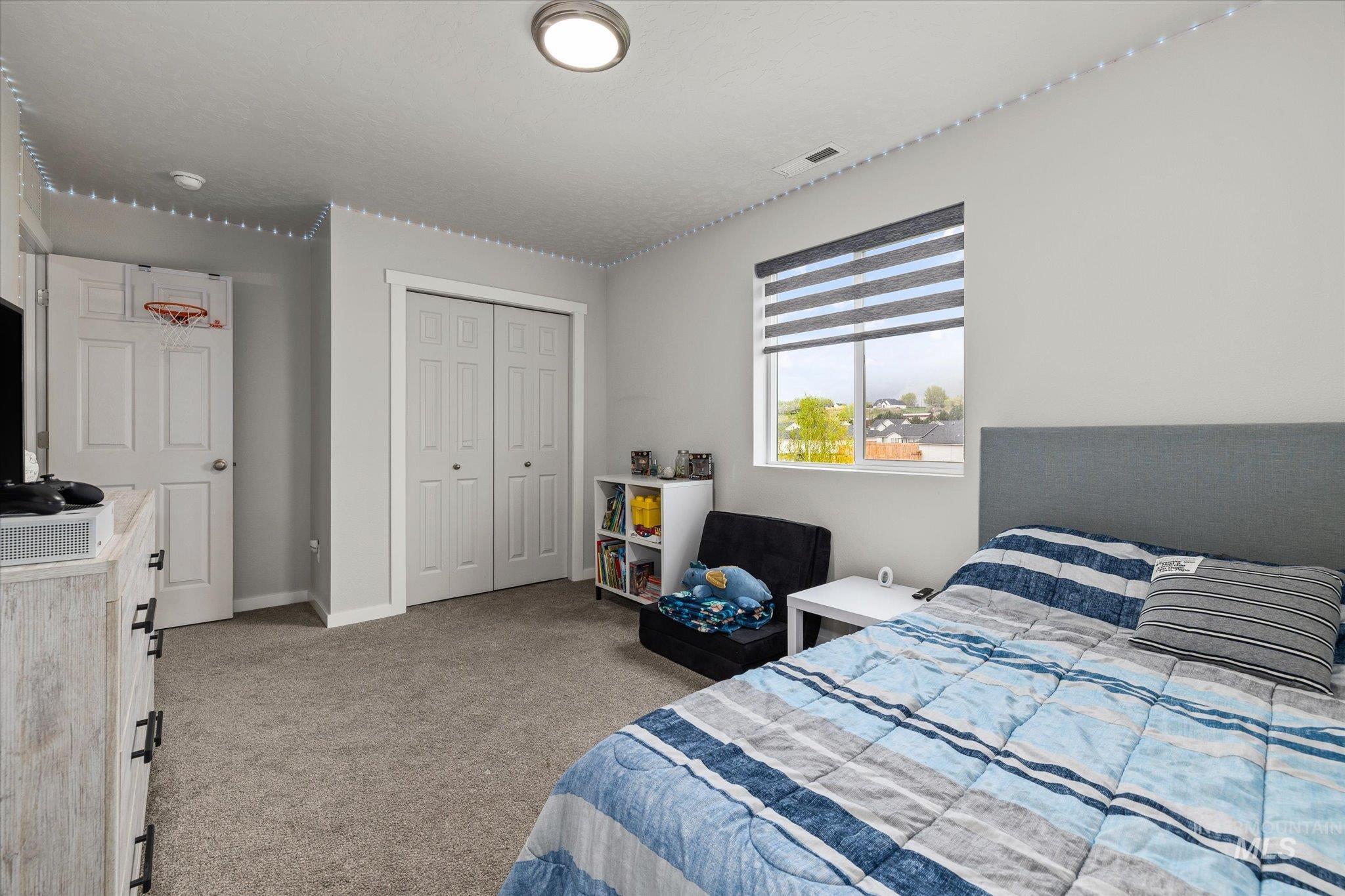 2024 Placerville Street Middleton, ID 83644 - Photo 25 of 38 Bedroom with light colored carpet and a closet