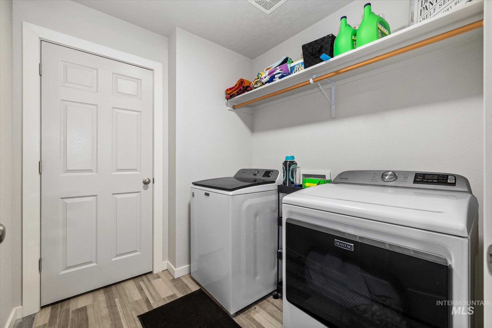 2024 Placerville Street Middleton, ID 83644 - Photo 26 of 38 Laundry room with light wood-type flooring and separate washer and dryer