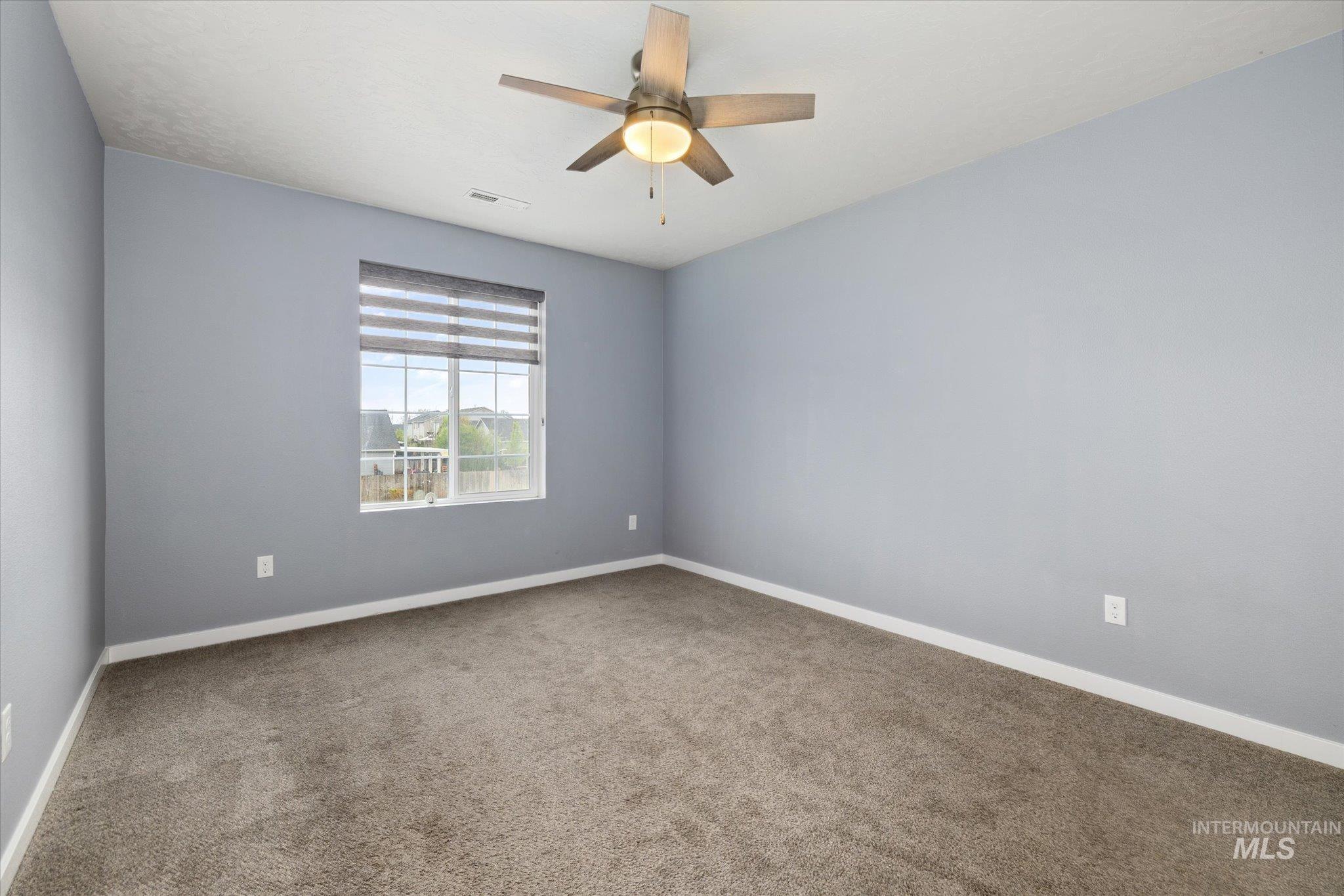 2024 Placerville Street Middleton, ID 83644 - Photo 27 of 38 Empty room with carpet flooring and a ceiling fan