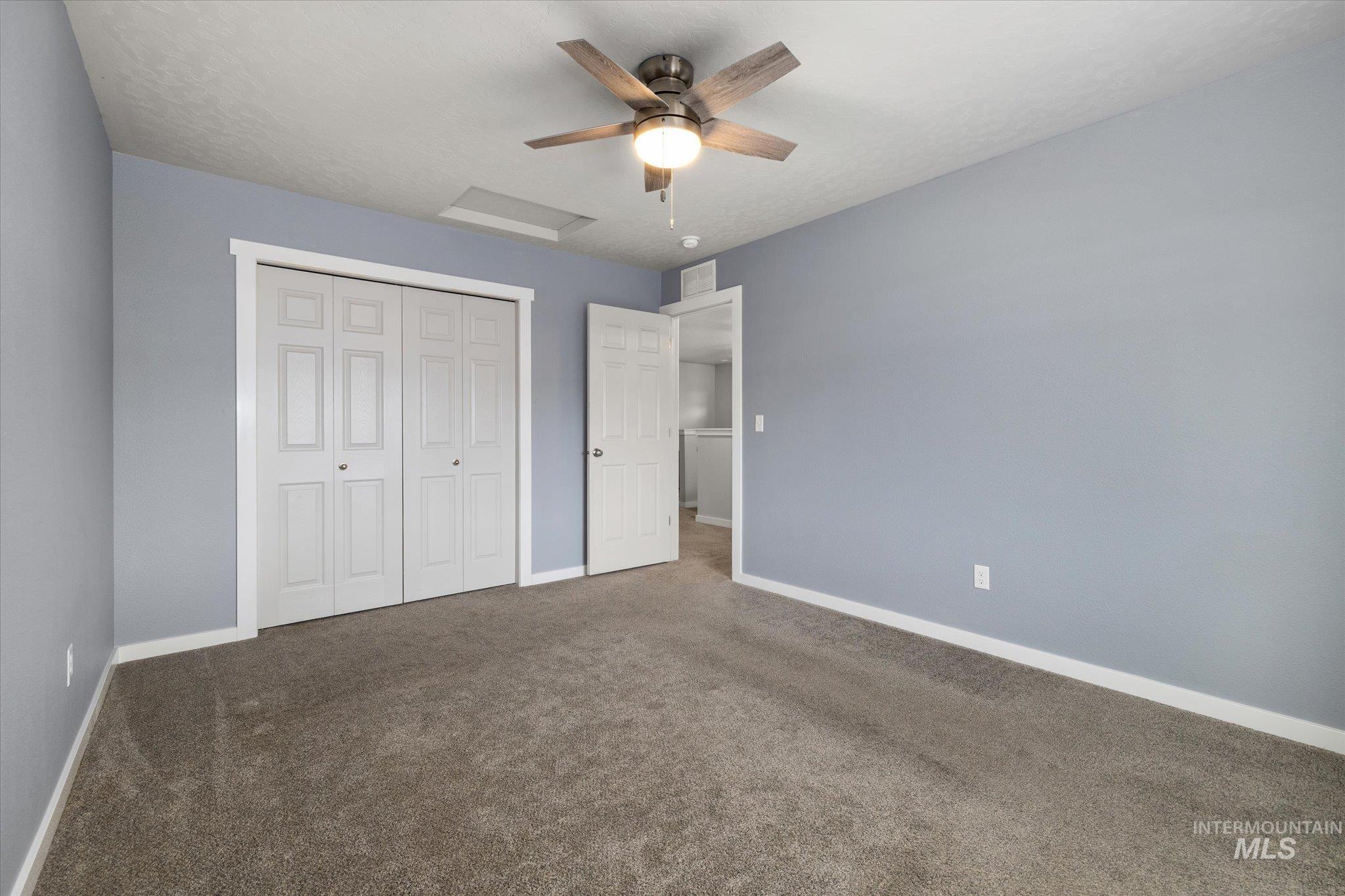 2024 Placerville Street Middleton, ID 83644 - Photo 28 of 38 Unfurnished bedroom with dark colored carpet, ceiling fan, and a closet