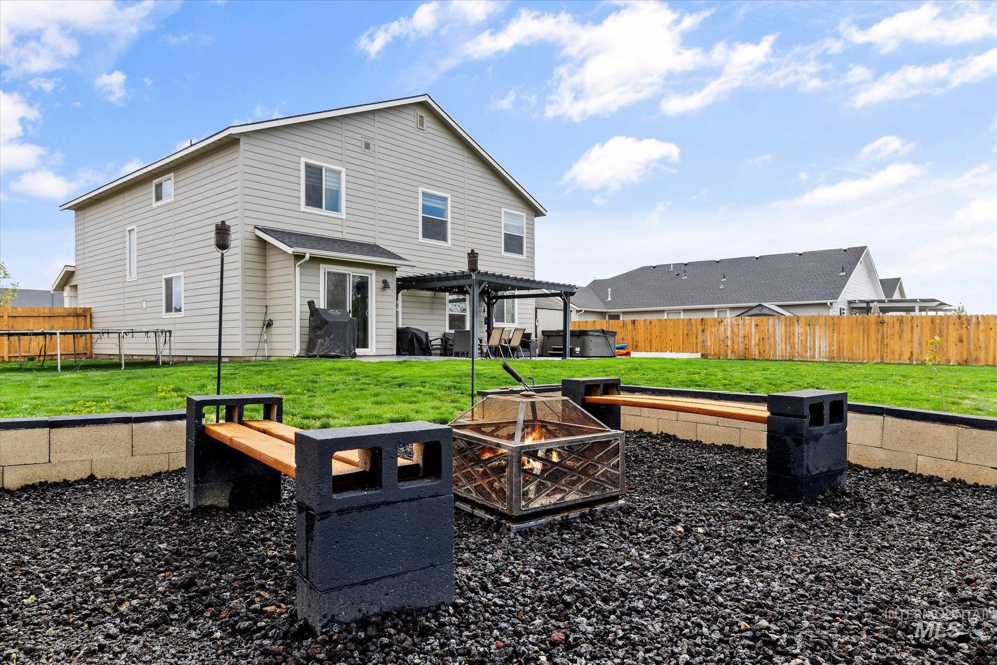 2024 Placerville Street Middleton, ID 83644 - Photo 33 of 38 Rear view of house featuring a fire pit, a patio, a fenced backyard, and a pergola
