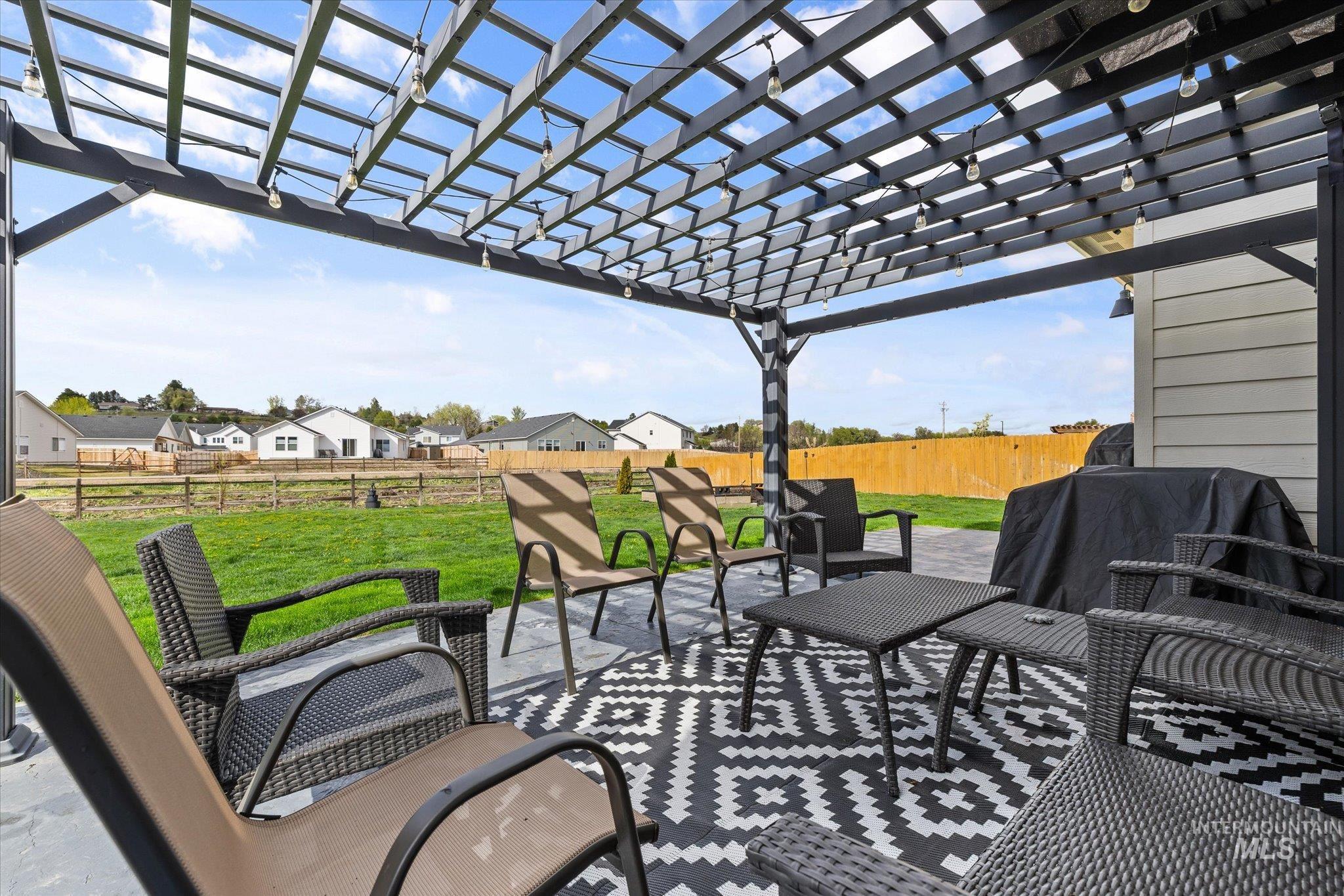 2024 Placerville Street Middleton, ID 83644 - Photo 36 of 38 Fenced backyard featuring a pergola, a patio area, grilling area, and outdoor furniture