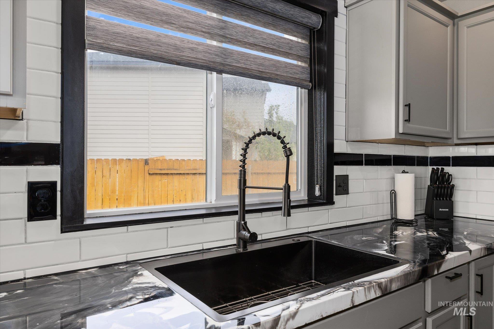 2024 Placerville Street Middleton, ID 83644 - Photo 5 of 38 Kitchen featuring gray cabinets, healthy amount of natural light, and decorative backsplash