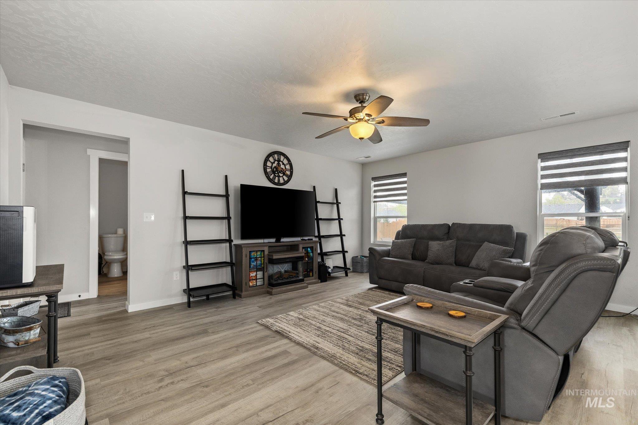 2024 Placerville Street Middleton, ID 83644 - Photo 9 of 38 Living area featuring a ceiling fan and light wood-type flooring