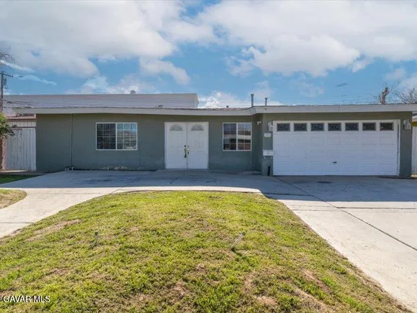 a view of pool with yard in front of it