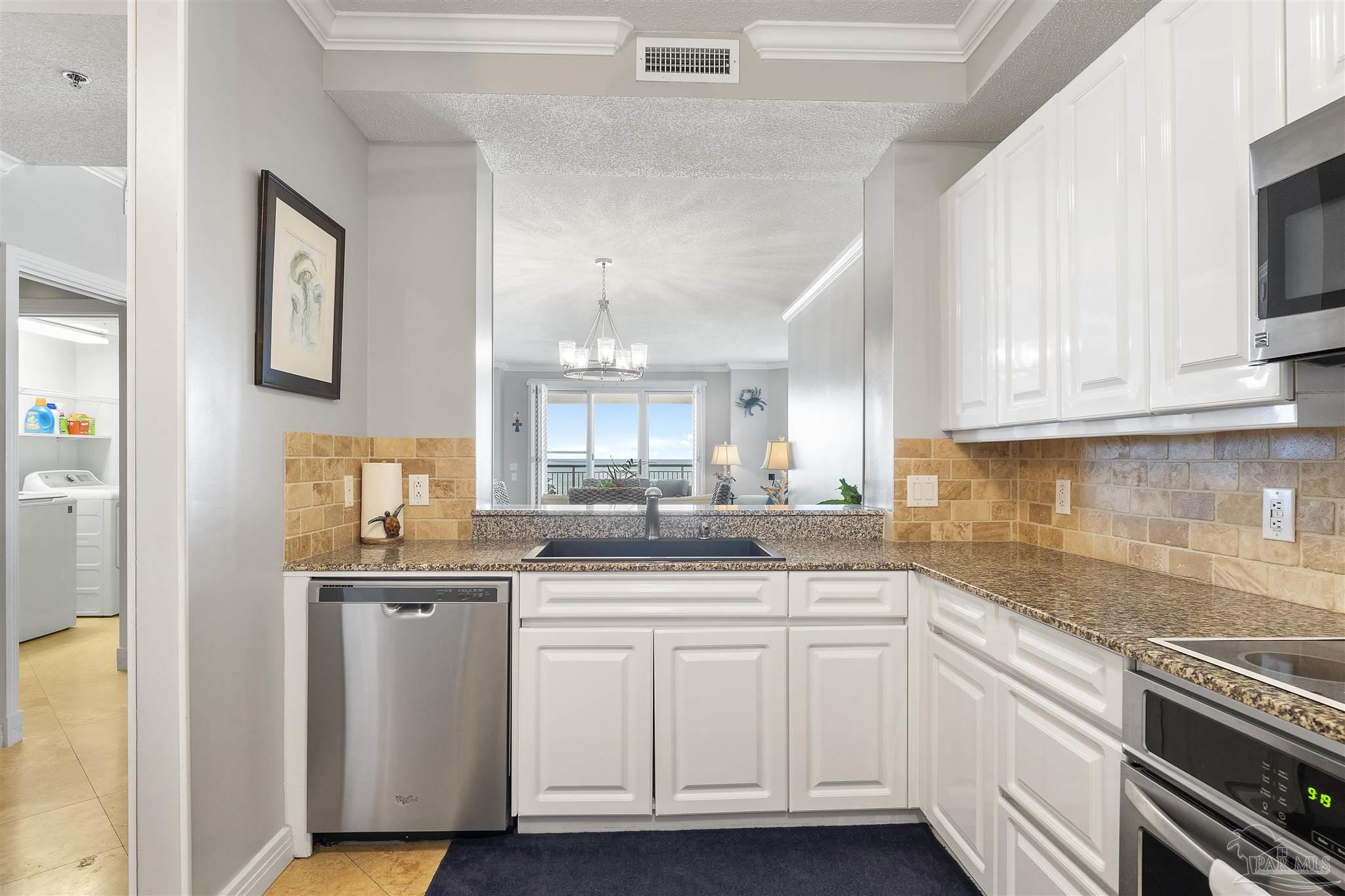 13601 Perdido Key Drive, Unit W2C Perdido Key, FL 32507 - Photo 21 of 63 a kitchen with white cabinets appliances and a sink