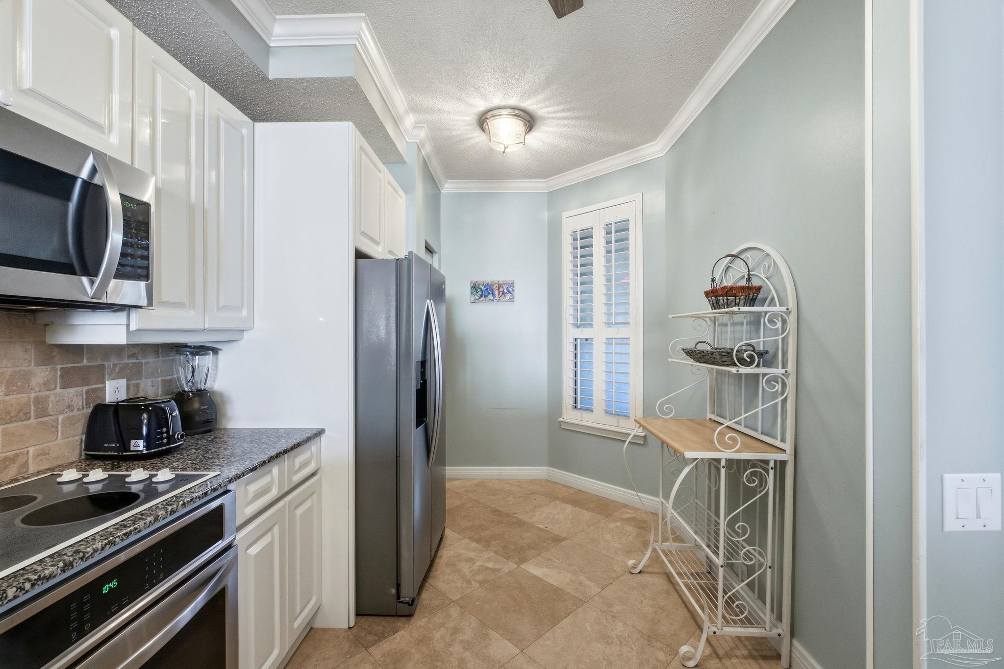 13601 Perdido Key Drive, Unit W2C Perdido Key, FL 32507 - Photo 26 of 63 a kitchen with stainless steel appliances granite countertop a refrigerator and a stove