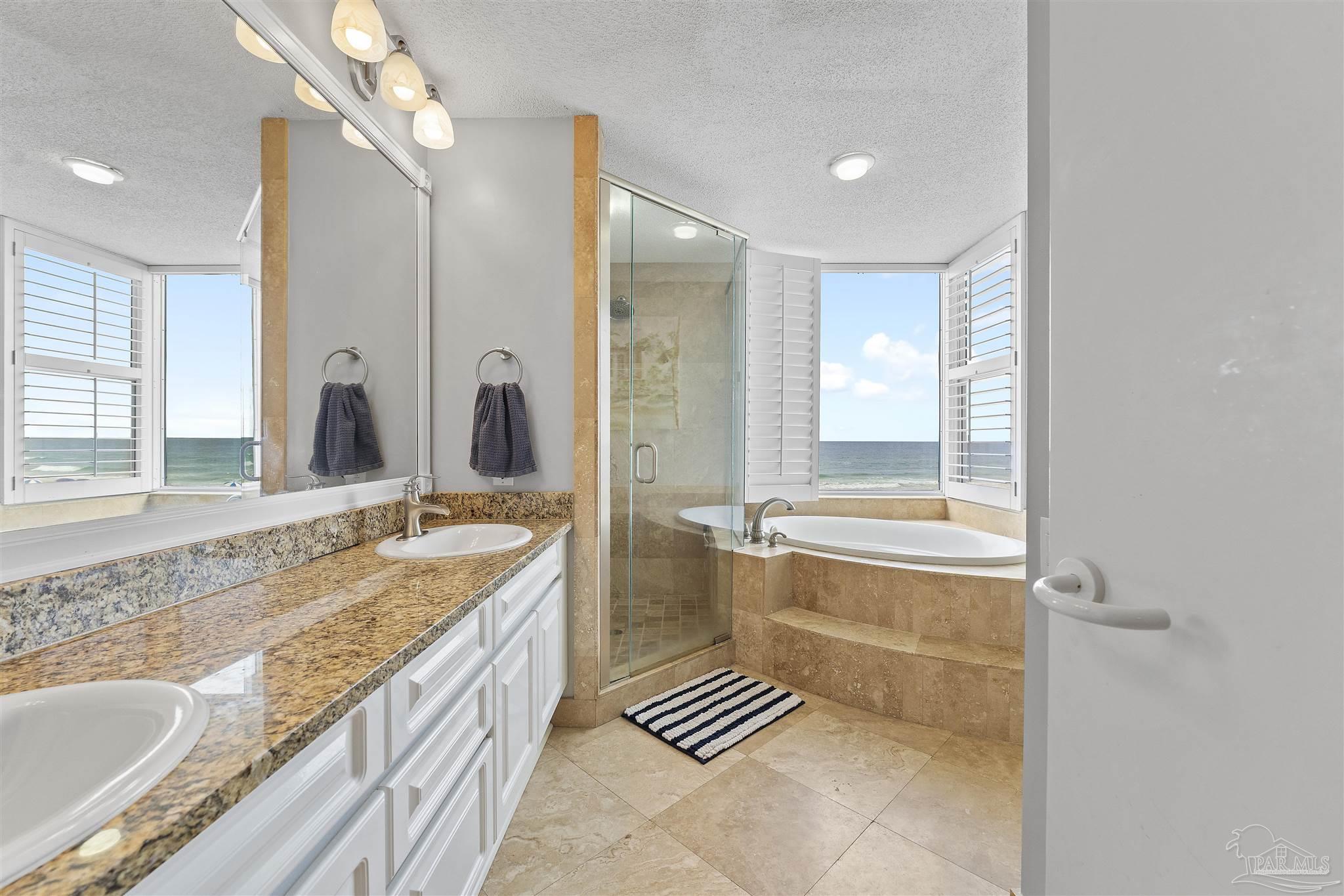 13601 Perdido Key Drive, Unit W2C Perdido Key, FL 32507 - Photo 36 of 63 a spacious bathroom with a granite countertop tub sink and mirror