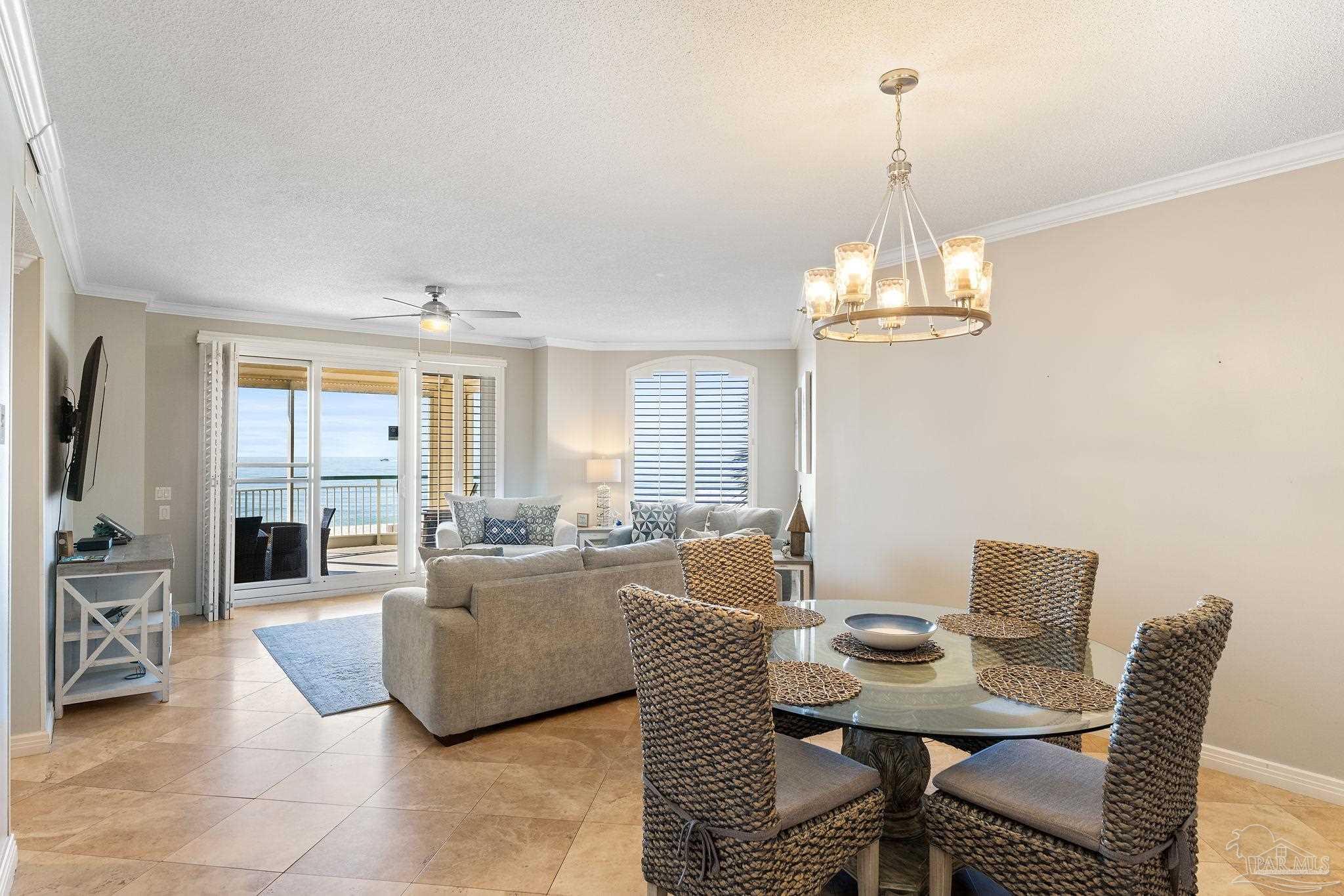 13601 Perdido Key Drive, Unit W2C Perdido Key, FL 32507 - Photo 10 of 63 a living room with furniture a chandelier and a flat screen tv
