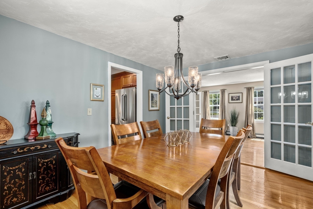 16 Jasmine Road Medway, MA 02053 - Photo 15 of 41 a view of a dining room with furniture wooden floor and chandelier