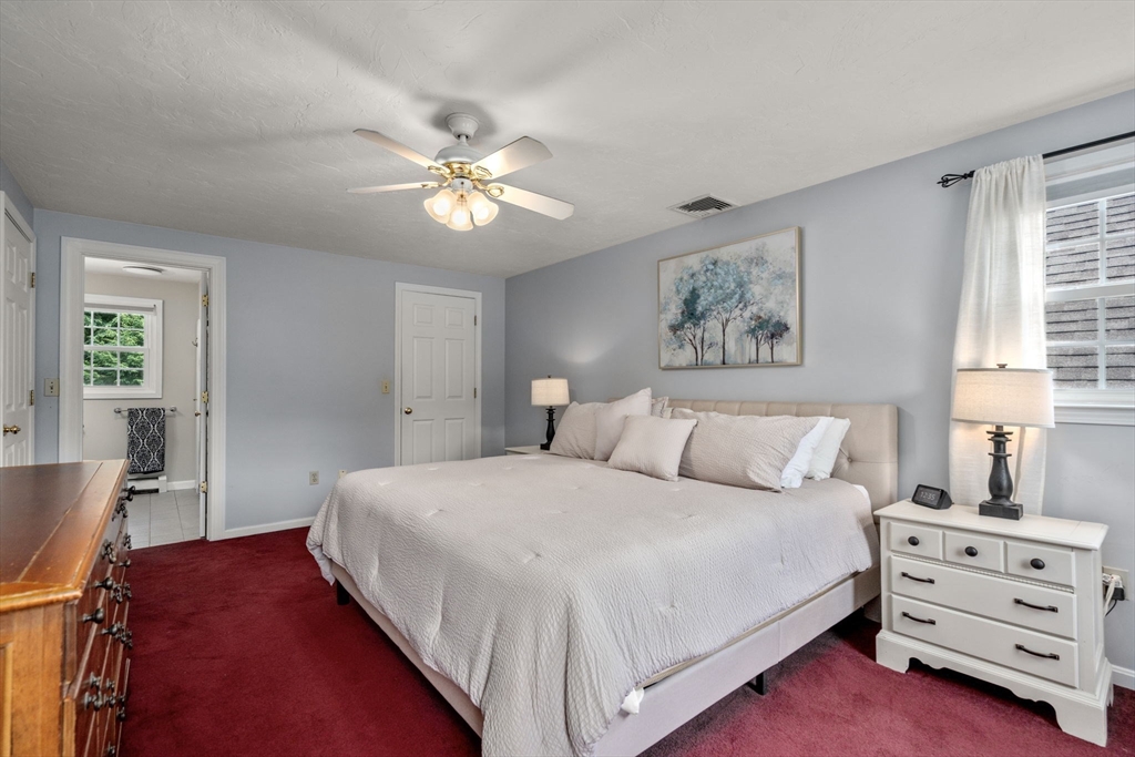 16 Jasmine Road Medway, MA 02053 - Photo 22 of 41 a bedroom with a bed and a chandelier