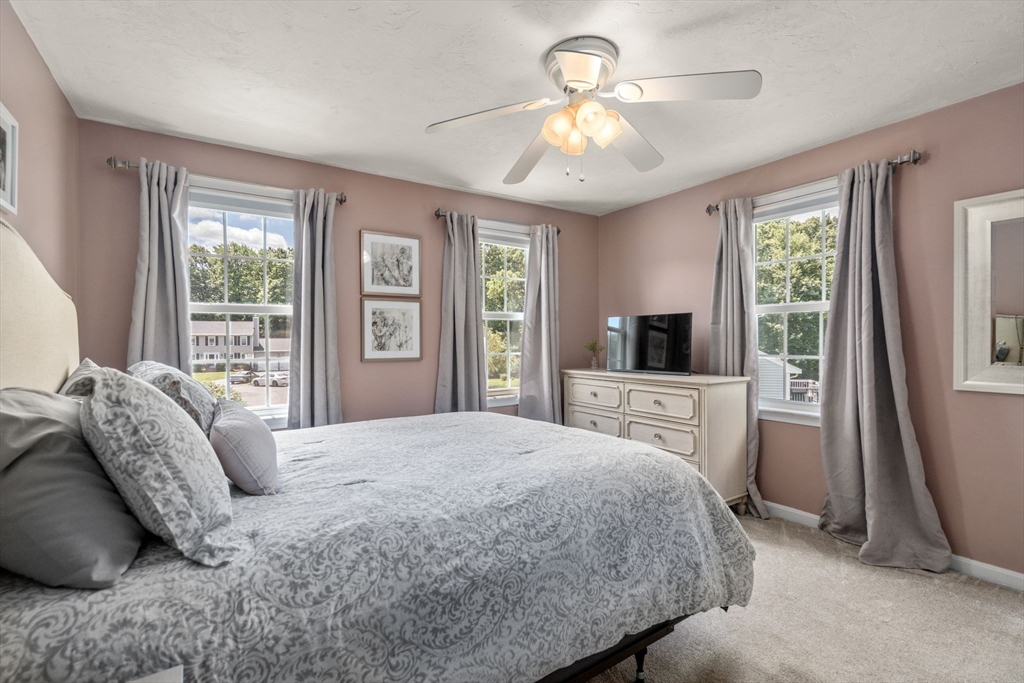 16 Jasmine Road Medway, MA 02053 - Photo 24 of 41 a bedroom with a large bed and a chandelier