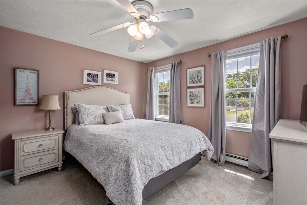 16 Jasmine Road Medway, MA 02053 - Photo 25 of 41 a bedroom with a large bed and a chandelier