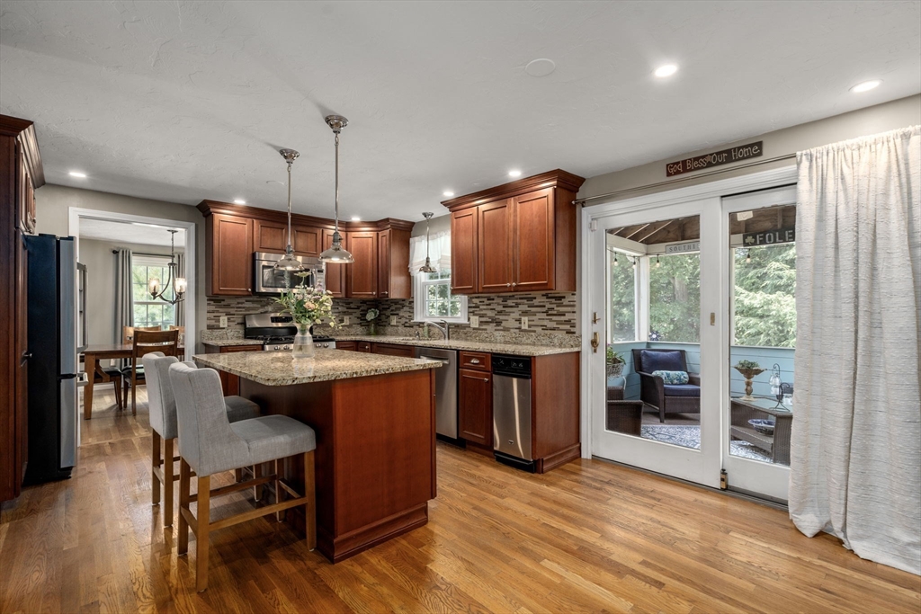 16 Jasmine Road Medway, MA 02053 - Photo 5 of 41 a kitchen with stainless steel appliances granite countertop a refrigerator a stove top oven a sink dishwasher and white cabinets with wooden floor