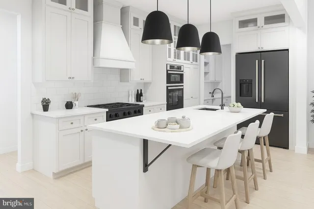 a kitchen with stainless steel appliances kitchen island granite countertop a sink a refrigerator and cabinets