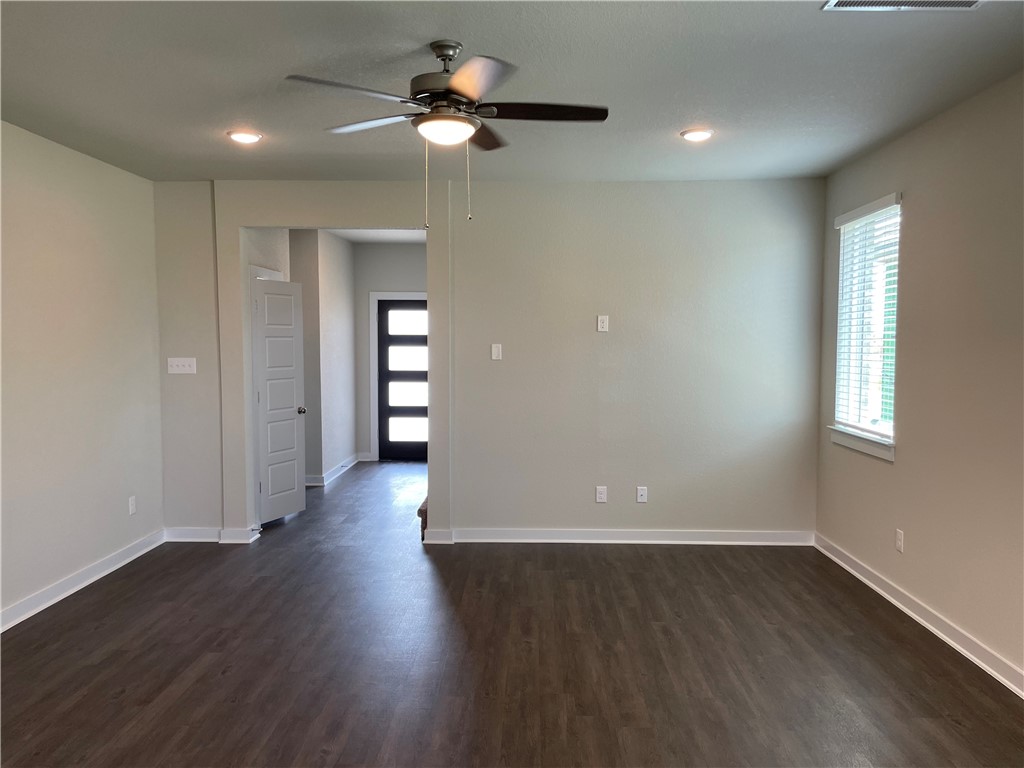 609 Paddock Lane Georgetown, TX 78626 - Photo 20 of 40 Rich wood-look flooring and recessed lighting define this versatile open living space.
