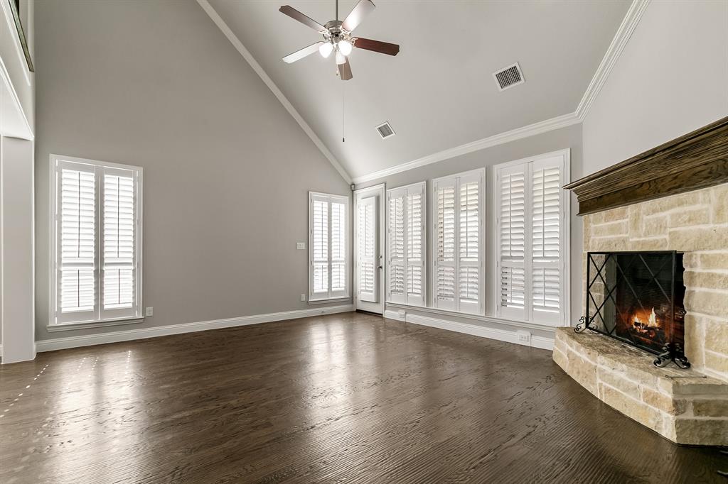 2936 Prescott The Colony, TX 75056 - Photo 6 of 28 an empty room with wooden floor fireplace and windows