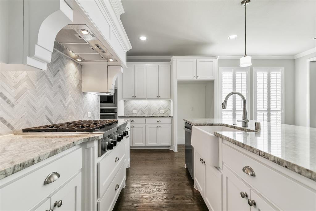 2936 Prescott The Colony, TX 75056 - Photo 8 of 28 a kitchen with granite countertop a stove sink and cabinets